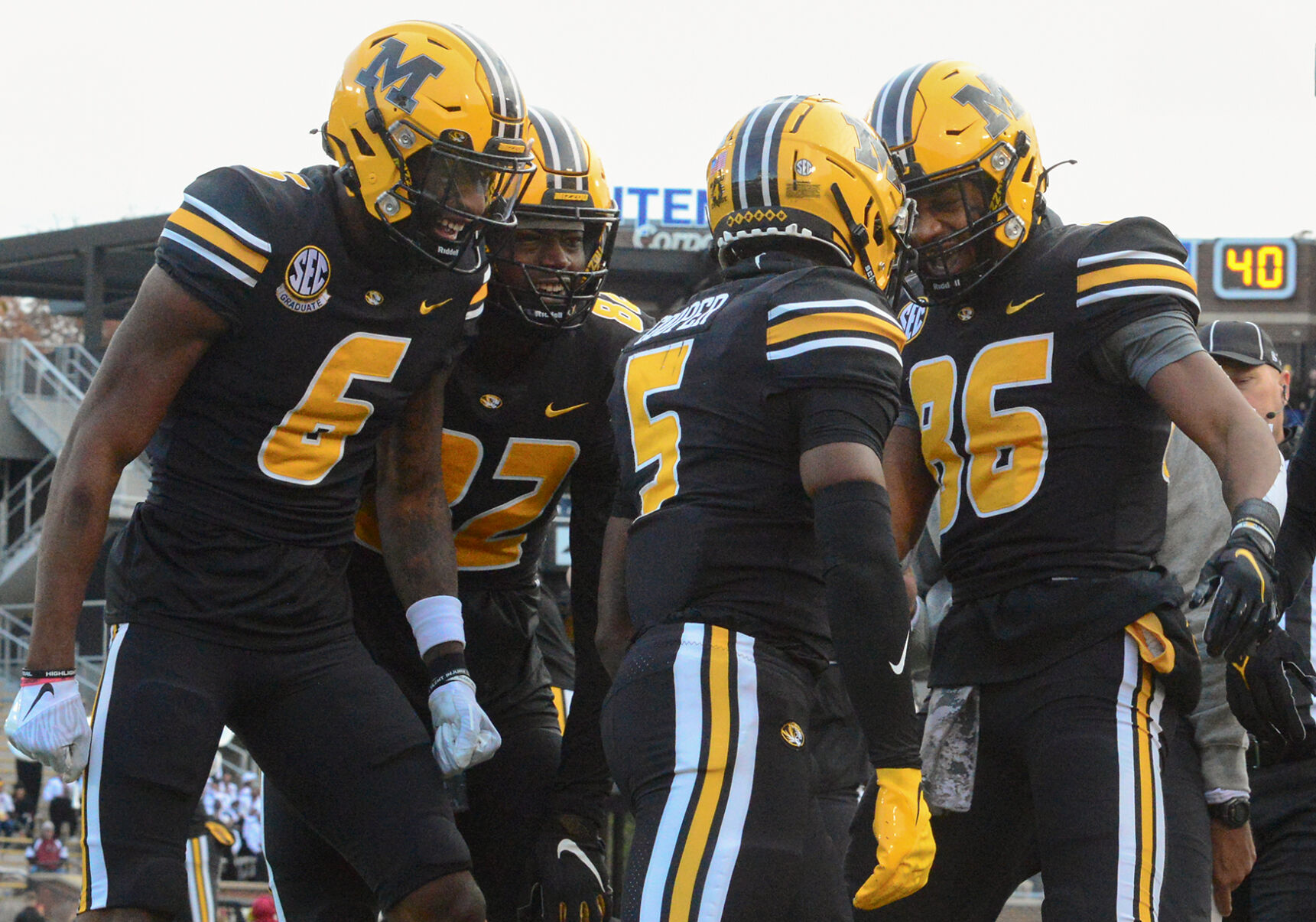 From left, Keke Chism, Daniel Parker, Jr. and Tauskie Dove celebrate with Mookie Cooper, center,
